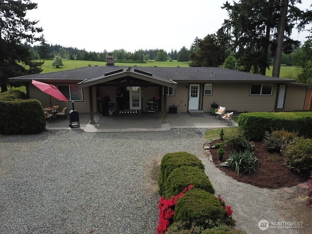 39418 200th Ave SE, Auburn, WA 98092 - back of property with a patio, a shingled roof, and a chimney
