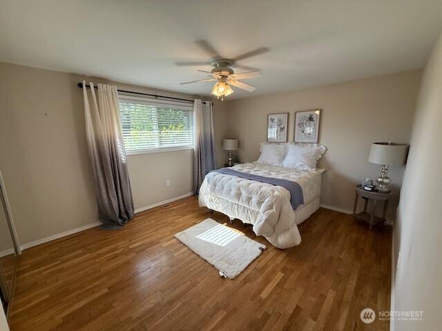39418 200th Ave SE, Auburn, WA 98092 - bedroom with wood finished floors, baseboards, and ceiling fan