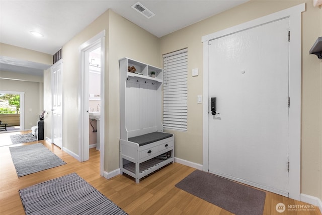 mudroom featuring light wood-style flooring and baseboards