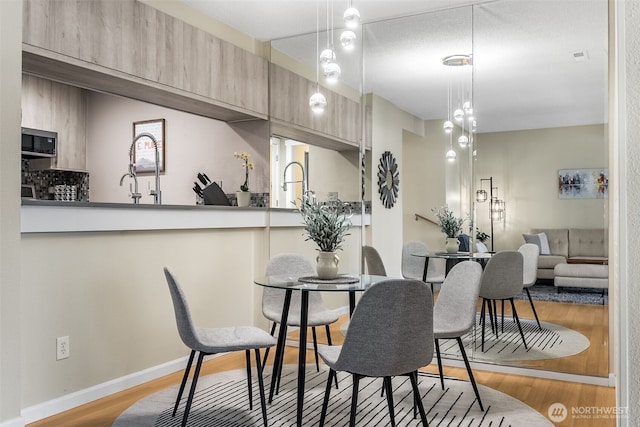 dining room with wood finished floors and baseboards