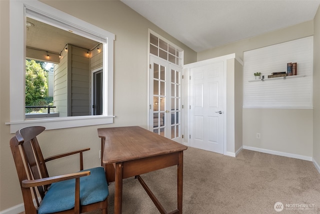 living area with carpet flooring, french doors, and baseboards