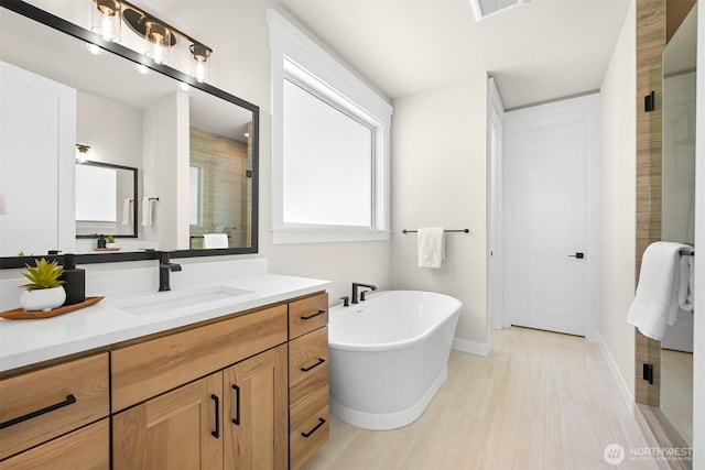 5411 Lonicera Dr, Blaine, WA 98230 - bathroom featuring a shower stall, a freestanding bath, vanity, and baseboards