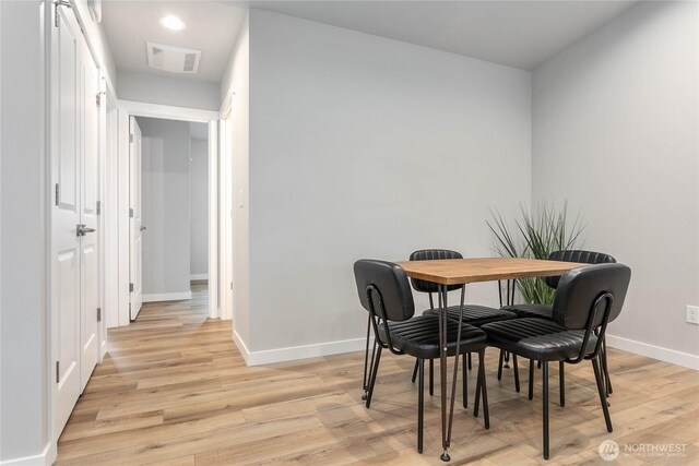 dining space with light wood finished floors, baseboards, and recessed lighting