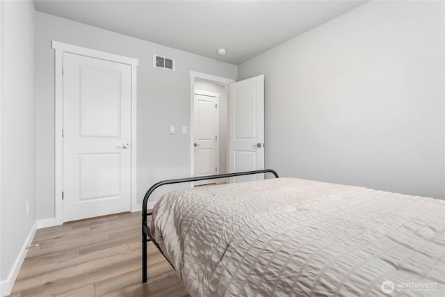 bedroom featuring light wood-style floors and baseboards