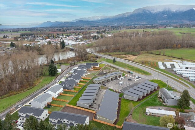 aerial view of residential area featuring a water and mountain view
