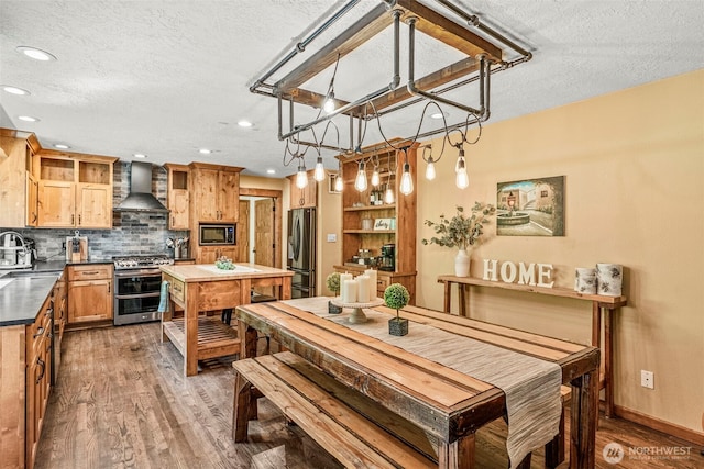 161 Mill Creek Rd, Longview, WA 98632 - dining space featuring a textured ceiling, wood finished floors, recessed lighting, and baseboards