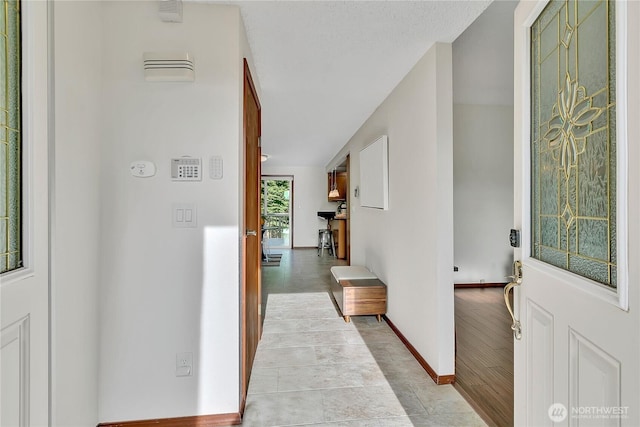 hall featuring baseboards