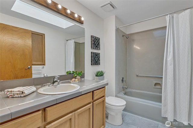 full bath featuring tile patterned floors, toilet, shower / bath combo with shower curtain, and vanity