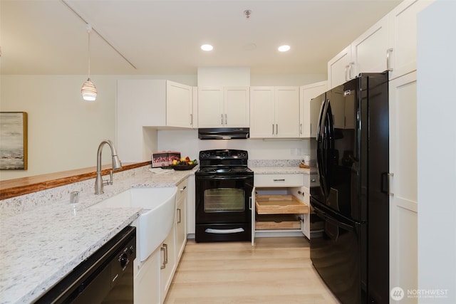 1750 152nd Ave NE Unit W110, Bellevue, WA 98007 - kitchen with black appliances, range hood, a sink, white cabinetry, and recessed lighting