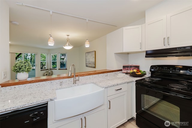 1750 152nd Ave NE Unit W110, Bellevue, WA 98007 - kitchen with black appliances, under cabinet range hood, a sink, white cabinets, and vaulted ceiling