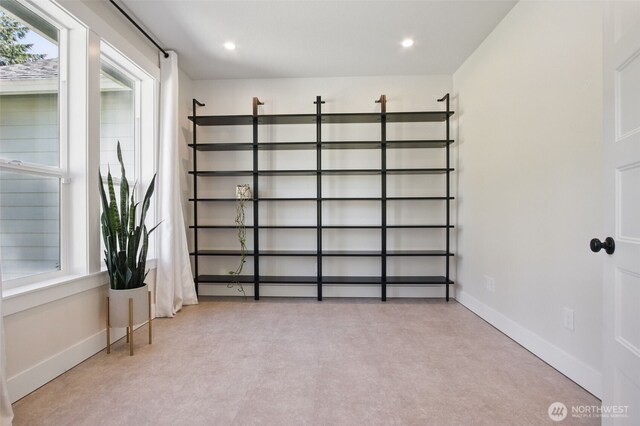 interior space with baseboards and recessed lighting
