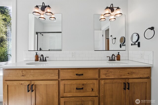 bathroom featuring backsplash, double vanity, and an enclosed shower