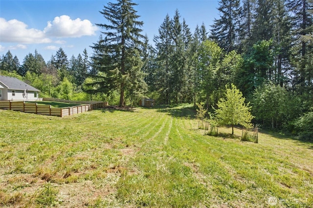 view of yard with a view of trees
