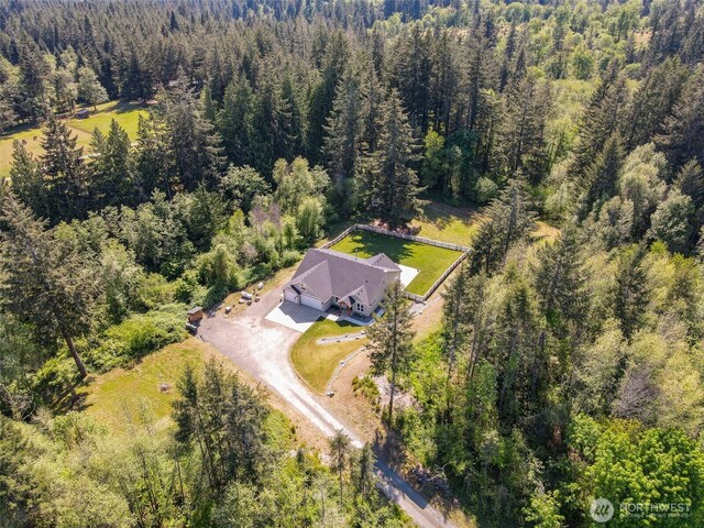 view of subject property featuring a heavily wooded area