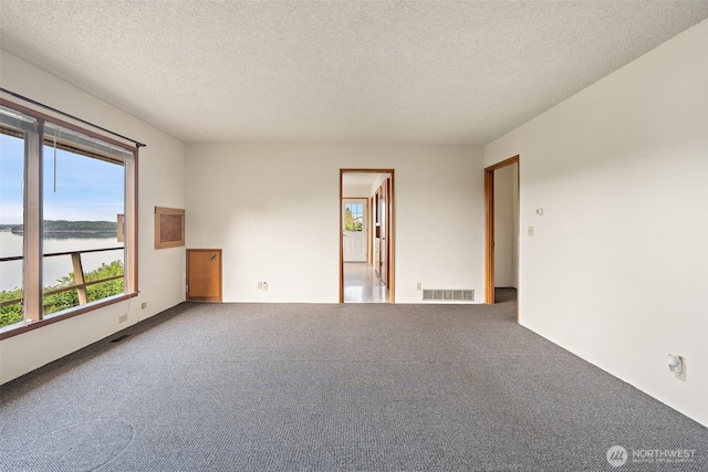 1038 Fairmount Ave, Shelton, WA 98584 - carpeted empty room with a water view and a textured ceiling