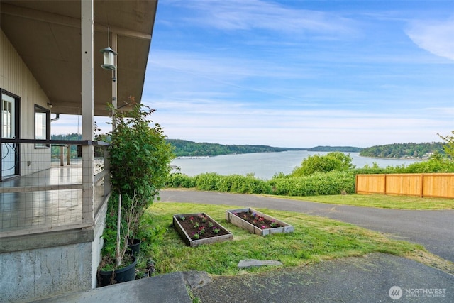 1038 Fairmount Ave, Shelton, WA 98584 - view of yard with a vegetable garden, a water view, and fence