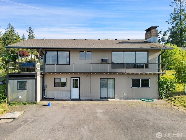 1038 Fairmount Ave, Shelton, WA 98584 - view of front of home featuring roof with shingles and a chimney