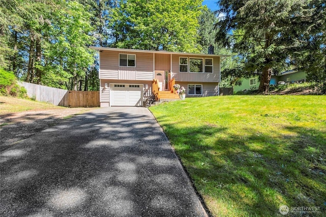 bi-level home with driveway and an attached garage