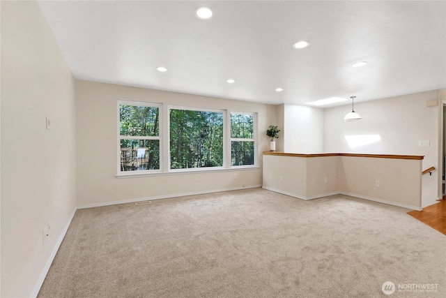 unfurnished room with carpet floors, recessed lighting, and baseboards