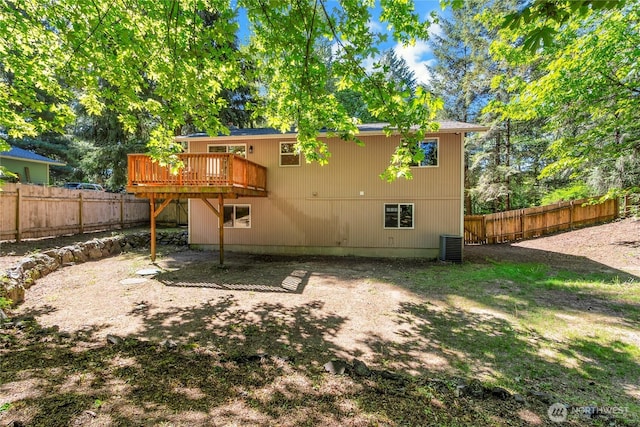 rear view of house with a deck and a fenced backyard