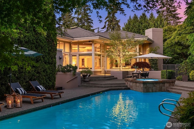 swimming pool with an in-ground hot tub and a patio