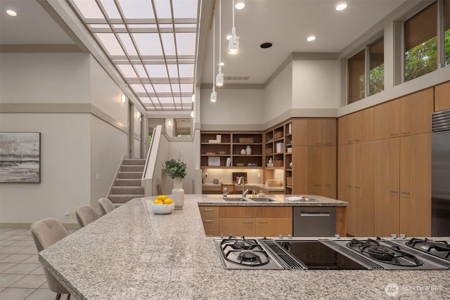 kitchen featuring a sink, modern cabinets, light stone countertops, and recessed lighting