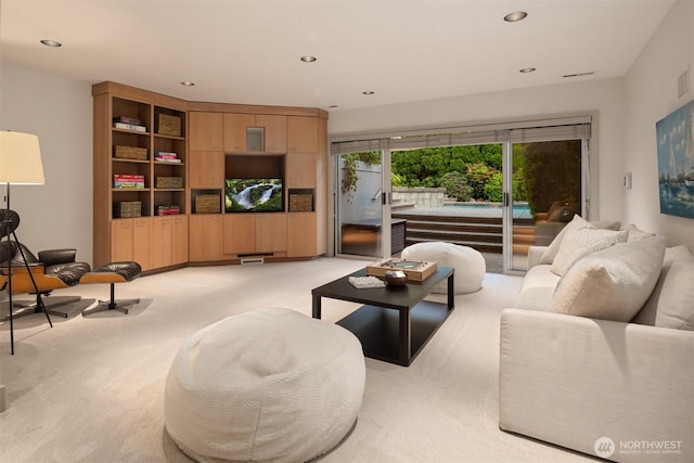living room featuring light carpet and recessed lighting