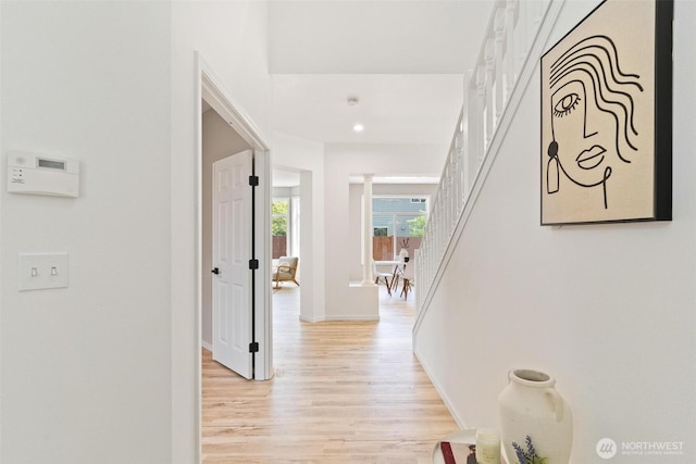 28648 226th Ave SE, Maple Valley, WA 98038 - hallway with light wood-style flooring, decorative columns, stairs, recessed lighting, and baseboards