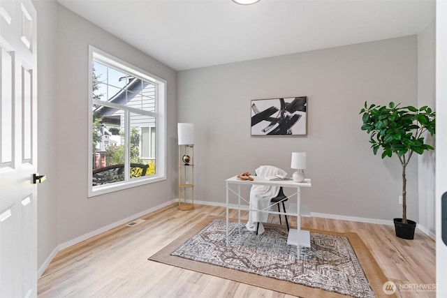 home office featuring wood finished floors and baseboards