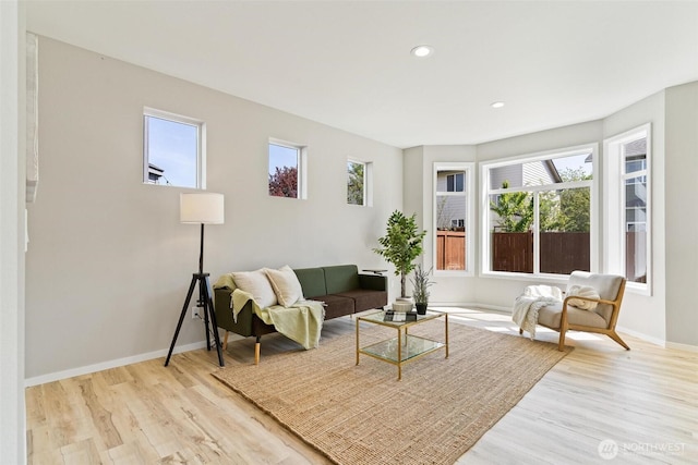 living area featuring wood finished floors, baseboards, and recessed lighting