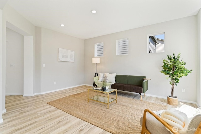 living area featuring wood finished floors, baseboards, and recessed lighting