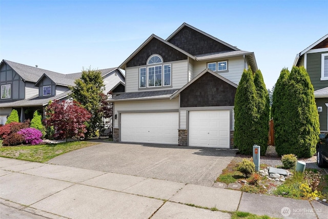 view of front facade with asphalt driveway, a garage, and stone siding
