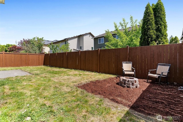 view of yard featuring a fire pit, a residential view, and a patio