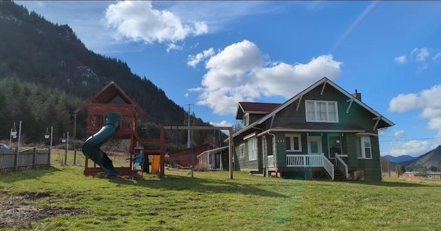 121 Temple Rd, Morton, WA 98356 - rear view of house featuring a playground, a porch, a lawn, a chimney, and a mountain view