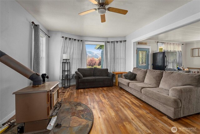 121 Temple Rd, Morton, WA 98356 - living room with wood finished floors, a ceiling fan, and baseboards