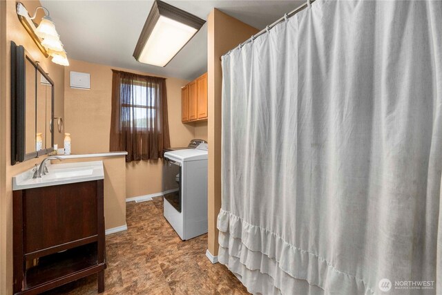 121 Temple Rd, Morton, WA 98356 - clothes washing area with washer / clothes dryer, cabinet space, and baseboards