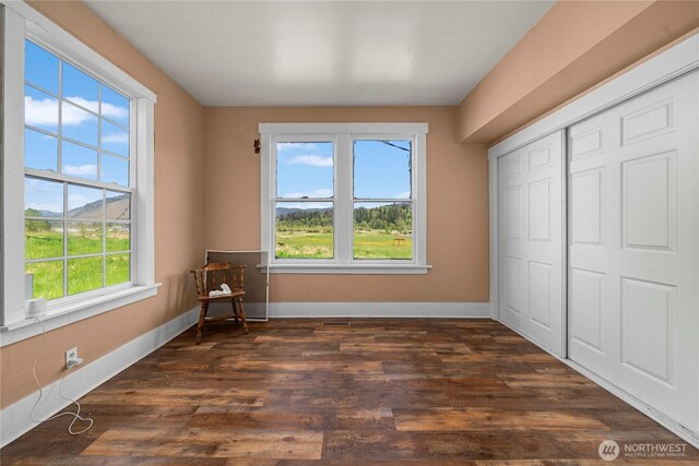 121 Temple Rd, Morton, WA 98356 - unfurnished bedroom with baseboards, dark wood finished floors, and a closet