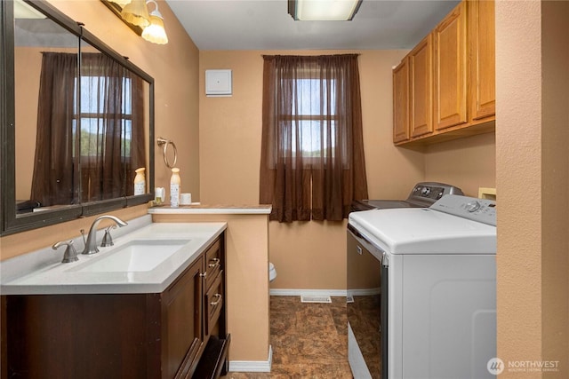 121 Temple Rd, Morton, WA 98356 - clothes washing area featuring baseboards, washing machine and dryer, and cabinet space