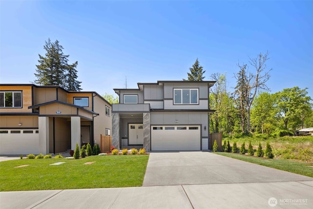 view of front of home with driveway, a front yard, and a garage