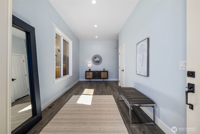 hallway featuring dark wood-style floors, recessed lighting, and baseboards