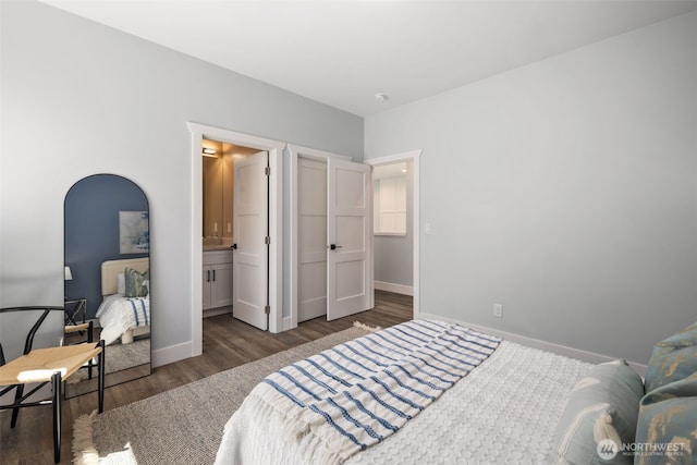 bedroom featuring wood finished floors and baseboards
