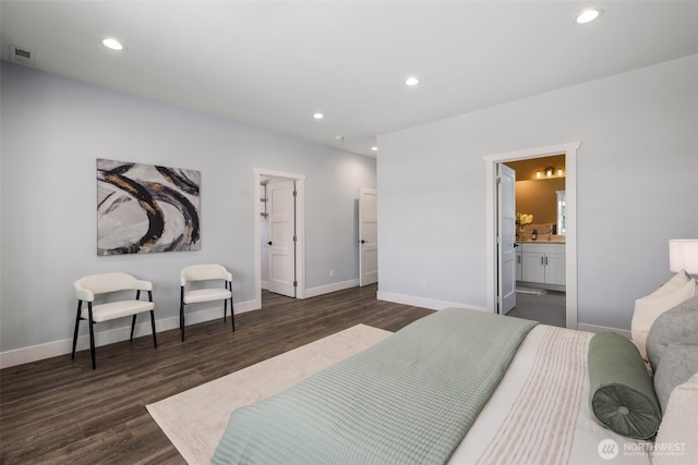 bedroom featuring dark wood-style flooring, recessed lighting, baseboards, and ensuite bath