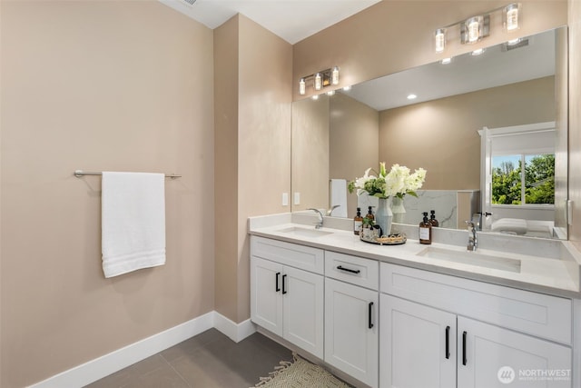 bathroom with tile patterned flooring, baseboards, and double vanity