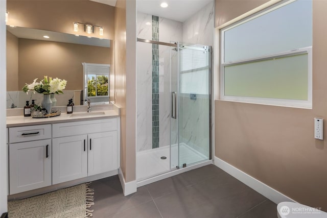 bathroom with baseboards, tile patterned flooring, a stall shower, vanity, and recessed lighting