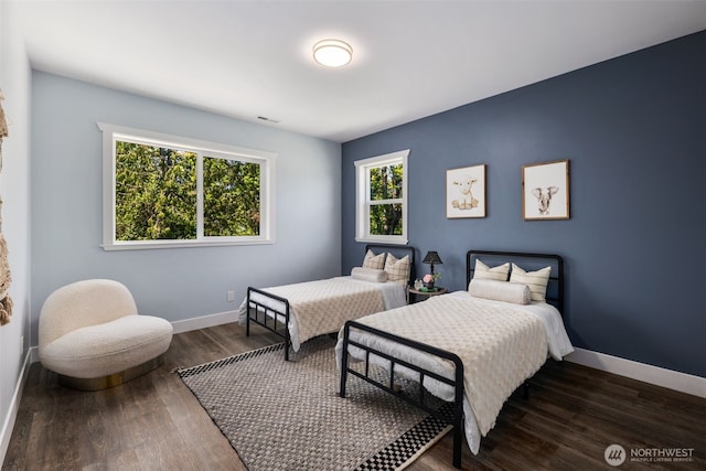 bedroom with baseboards and wood finished floors
