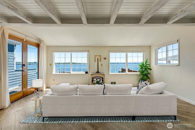 130 Priest Point Dr NE, Tulalip, WA 98271 - living area with beam ceiling, french doors, a water view, wood finished floors, and baseboards