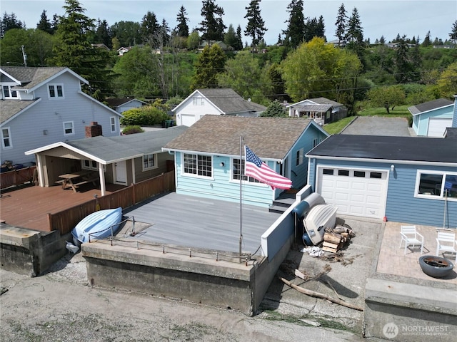 130 Priest Point Dr NE, Tulalip, WA 98271 - back of property with a deck, a garage, and concrete driveway