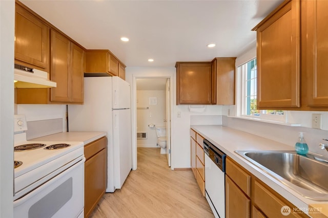 130 Priest Point Dr NE, Tulalip, WA 98271 - kitchen featuring white appliances, under cabinet range hood, a sink, light countertops, and light wood finished floors