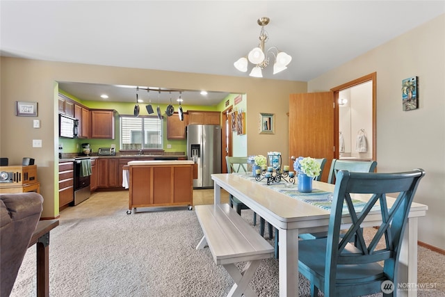 dining space with a chandelier and light carpet