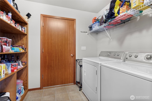 washroom featuring washer and clothes dryer and baseboards